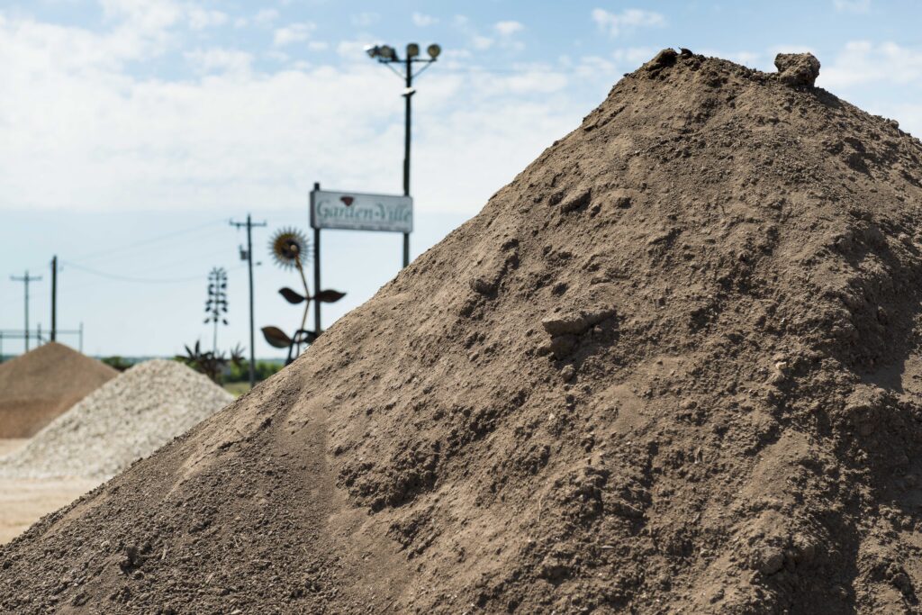 Piles of compost and soil at a Garden-Ville yard